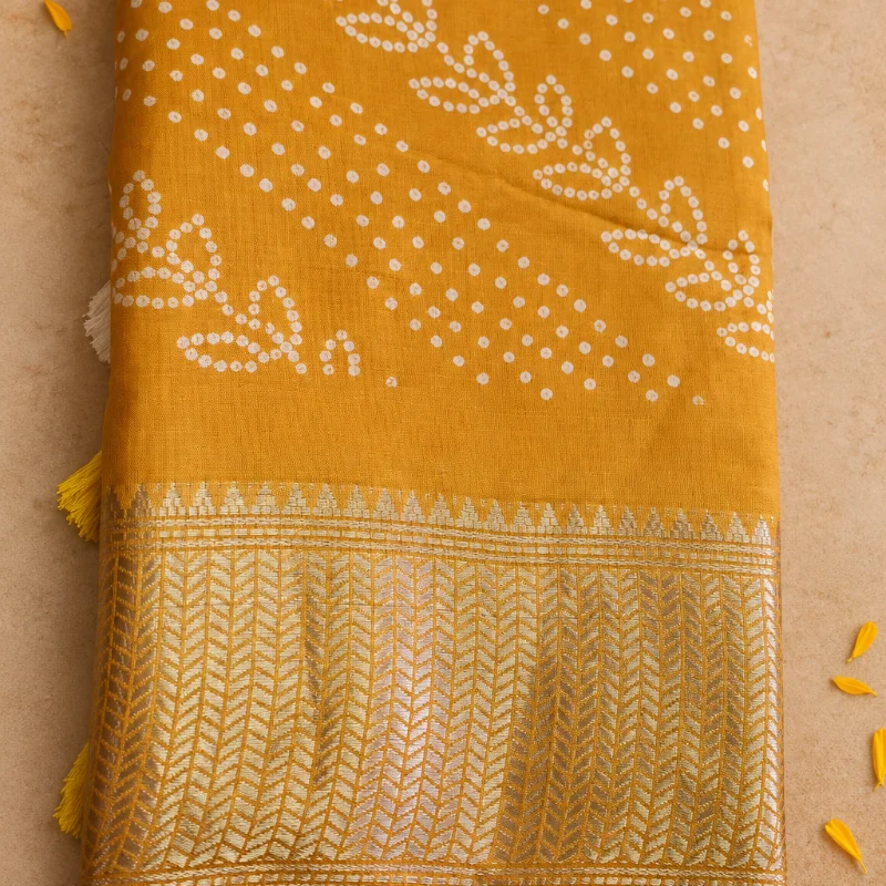 Radiant Mustard Yellow Bandhani Dola Silk Saree with intricate white vine amd dots with a luxurious woven gold Zari border.